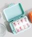 Weekly pill organizer with colorful days of the week labels on a light surface.