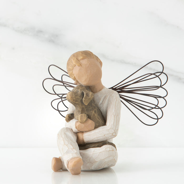 Decorative angel figurine holding a teddy bear on a white background