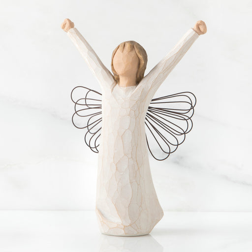 Standing angel in cream dress with wire wings, with both arms upraised