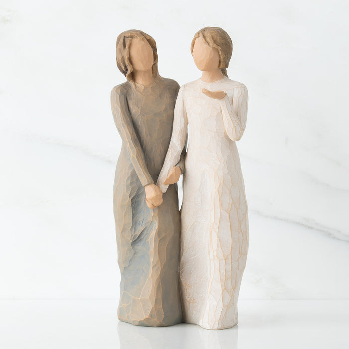 Two figurines holding hands on a white background
