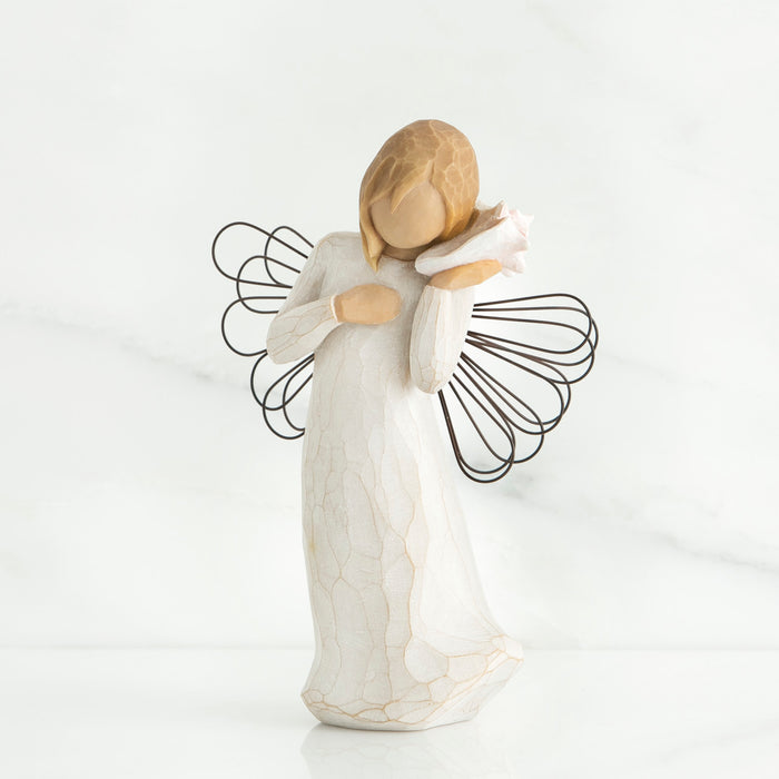 Angel figurine with wire wings on a white background